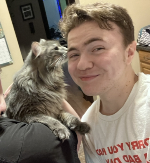 student posing with their cat